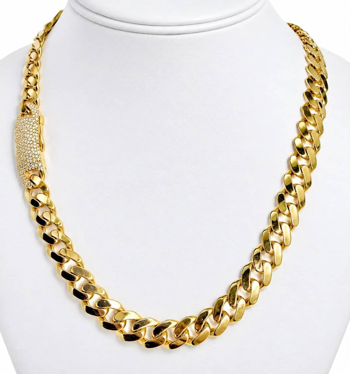 Gold Cuban link chain with a pavé box clasp on a white bust