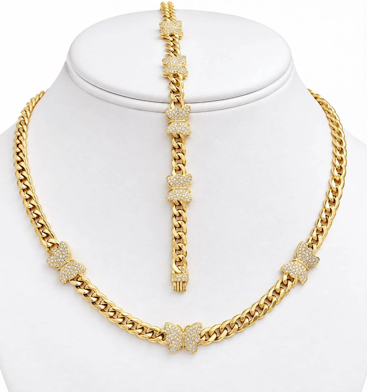 Gold Cuban necklace and bracelet set with pavé butterflies on a white bust