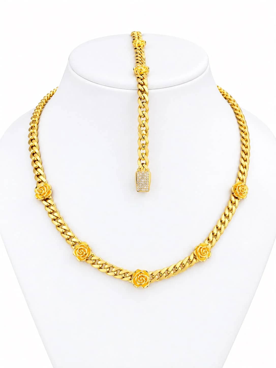 Gold Cuban necklace and bracelet set with sculpted roses on a white bust
